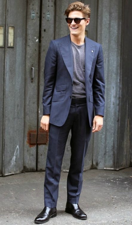 Dark brown chelsea boots pair well with a navy suit 