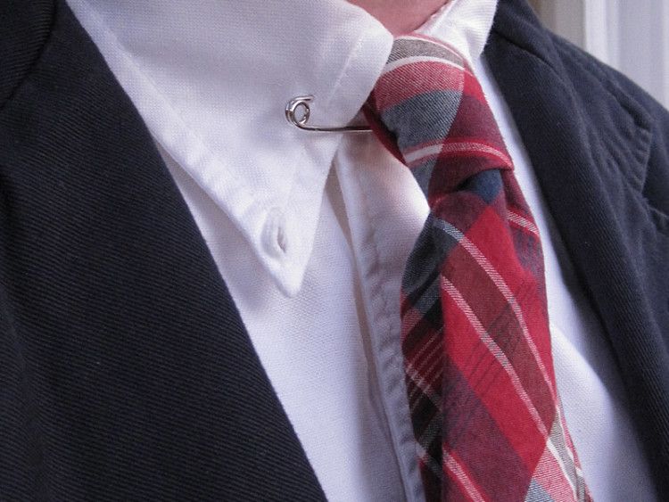 Collar pin lifts the tie for a slightly more dramatic look 