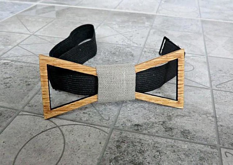 The wooden bow tie has a simple, adjustable lock 
