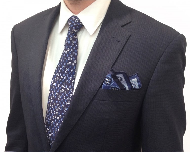 Pairing a tie and a calabrese scarf with a navy suit 