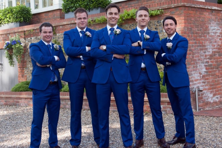 Groom, friends and witnesses in matching wedding suits 