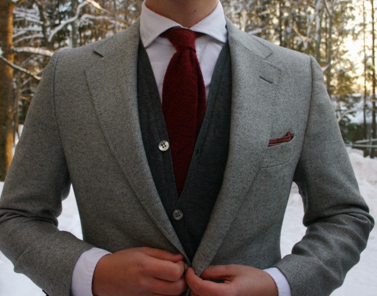 Wool tie paired with a cardigan and classic blazer 
