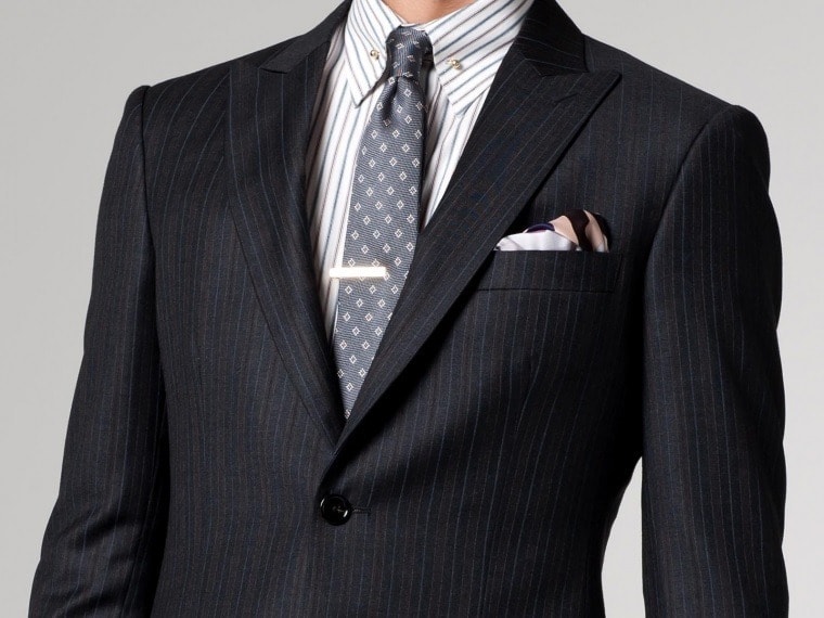 Striped suit and shirt paired with a small diamond print tie 
