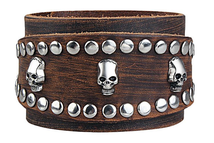 A brutal-looking bracelet for men made of leather with metal rivets and a skull decoration is especially desirable in street, rock and punk style 