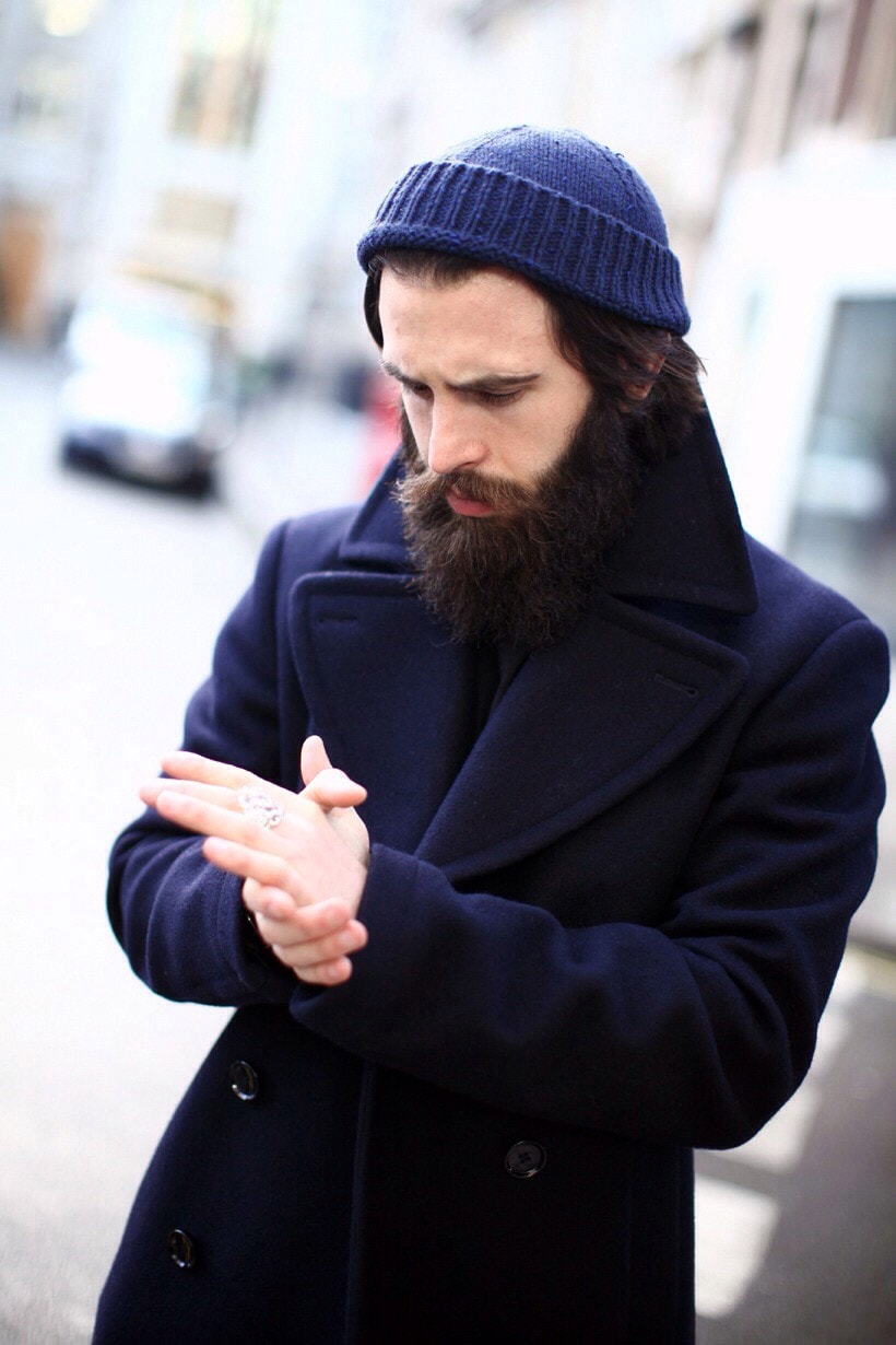 Man in blue coat and cap with lapel 