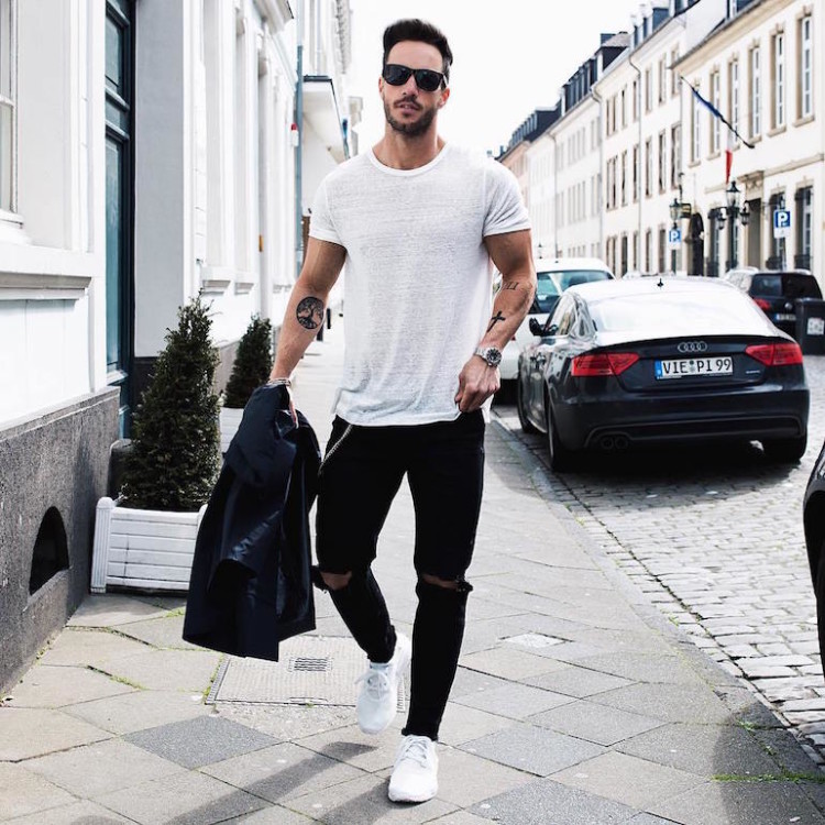 Pairing white athletic shoes with ripped jeans is a fail-safe way to infuse your look 